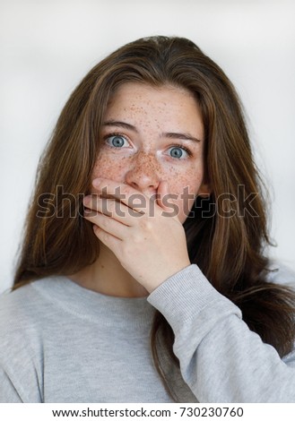 Portrait Of A Kind Girl With Freckles On Her Face In A Gray Jacket Looking Into Portrait Of A Kind Girl With Freckles On Her Face In A Gray Jacket Looking Into