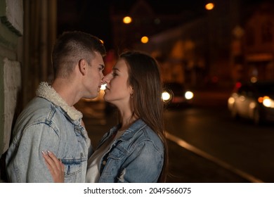 Portrait Of Kissing Young Couple On Night City Background. Beautiful Young Couple In Love. Romantic Date. Night City.