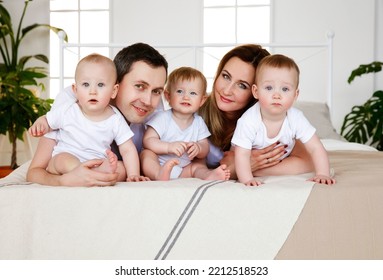 Portrait, Large Family, With Triplets On The Bed. Parents And Small Children. Medicine, Eco