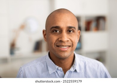 Portrait of Latin American man in formal clothes on light background