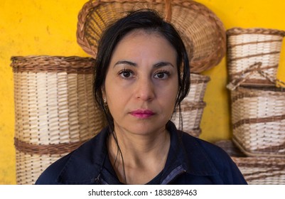 Portrait Of Latin Artisan Woman In Work Clothes With Background Wicker