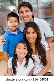 Portrait Of A Latin Family Smiling At Home Looking Very Happy 