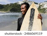 portrait of latin surfer man rides the tropical waves in Mexico Latin America, hispanic people surfing in summer sport activity