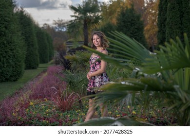 Portrait Of Latin Woman In Flowery Dress With Wavy Hair