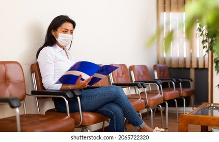 Portrait Of Latino American Woman In Face Mask Waiting For Job Interview At Office Lobby