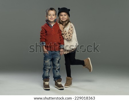 A portrait of a laughing girl and a smiling boy. Autumn style 