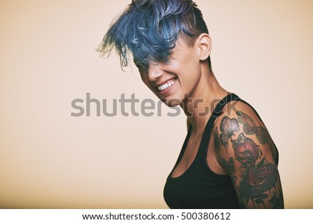 Portrait of laughing teenage girl with blue hair