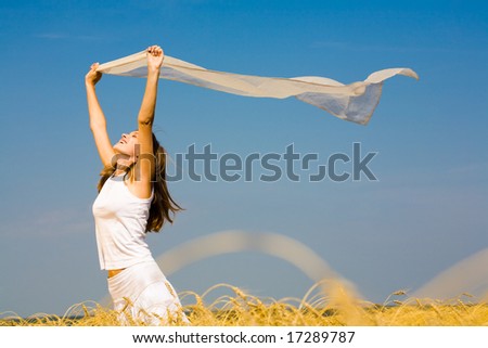 Portrait of laughing woman holding a silk cloth outdoor