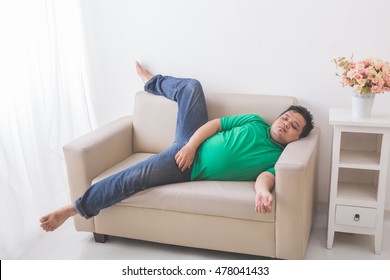 Portrait Of Lazy Fat Obese Man Sleeping On The Couch