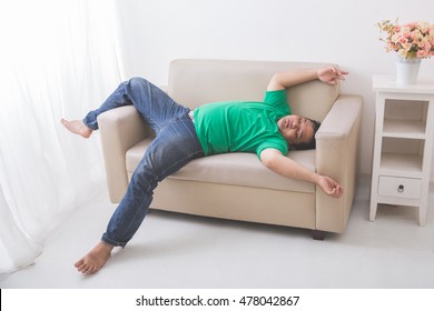 Portrait Of Lazy Fat Obese Man Sleeping On The Couch