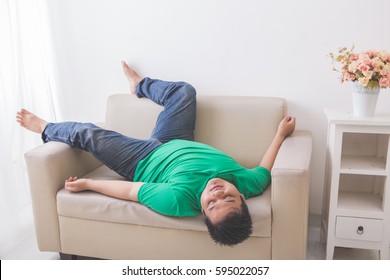 Portrait Of Lazy Fat Obese Man Sleeping On The Couch