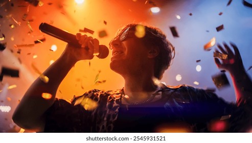 Portrait of a Lead Singer Performing at a Rock Concert Live on Stage with Confetti. Talented Musician Bringing His Unique Attitude, Playing Energetic Rock Hits. Young Band Playing For the Crowd - Powered by Shutterstock