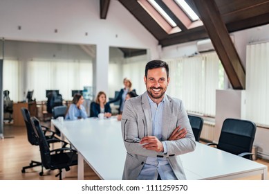 Portrait of a leader with business team behind. - Shutterstock ID 1111259570