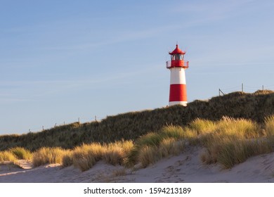 Portrait of lighthouse List West at Sylt Island with marram grass in the foreground - Powered by Shutterstock