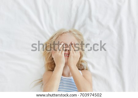 Similar – Image, Stock Photo Little girl covering eye with hand