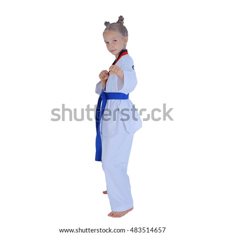 Portrait little adorable schoolgirl practicing taekwondo isolated on white background in a kimono with a blue sash. karate kid doing with fight stance. Fighting school lessons or classes for children