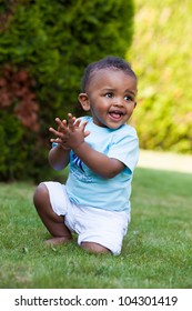 Portrait Of A Little African American Baby Boy Playing Outdoor In The Grass