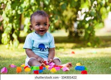 Portrait Of A Little African American Baby Boy Playing Outdoor In The Grass