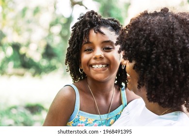 Portrait Of A Little Afro American Girl Looking At The Camera Smiling And Happy. Concept Love And Mothers Day, Divorce And Freedom