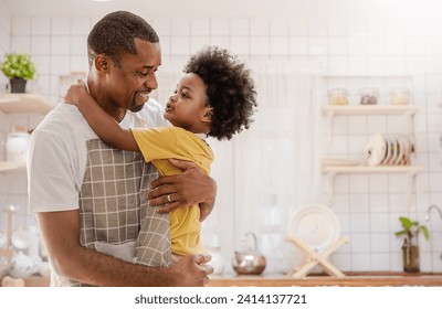 Portrait of little American African boy parent cooking preparing food with pan in the counter kitchen. Happy  family with father son, father's day, healthcare cooking plant based food concept - Powered by Shutterstock