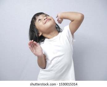 Portrait Of Little Asian Baby Girl Doing Goofy Dance, Fun Happy Expression