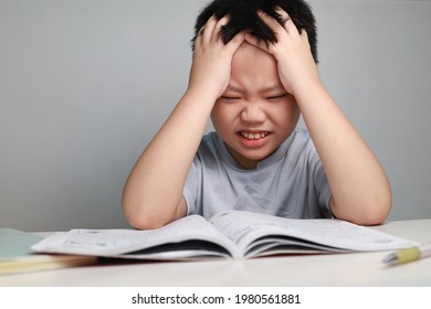 Portrait Of Little Asian Boy Bored, Frustrated And Fed Up Doing His Homework