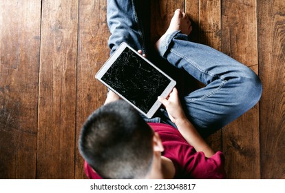 Portrait Of A Little Asian Boy, Kid Sad Face, Unhappy Child Sitting Holding  Broken Tablet Computer, Emotion Sad And Sad Face, Depressed Children Concept