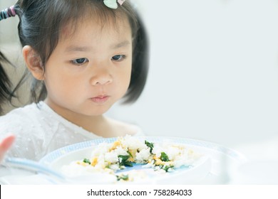 Portrait Of Little Asian Girl Child With No Appetite In Front Of The Meal.Concept Of Loss Of Appetite