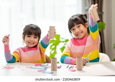 Portrait of a little asian girl cutting a paper in activities on DIY class at School.Scissors cut paper. - Powered by Shutterstock