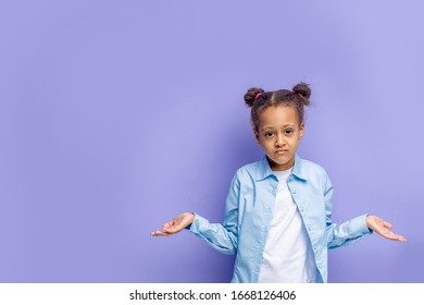 Portrait Of Little Beautiful Girl Standing Isolated Over Purple Background, Embarassed Facial Expression With Hands Up. Doubt Concept