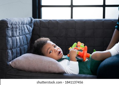 Portrait A Little Boy African American Newborns Crying On A Bed While Mother Consoled And Support As Her Son Cried. Inconsolable Cry Infant Mother Console Newborn. Family Concept.