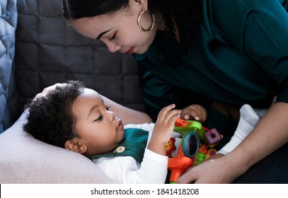 Portrait A Little Boy African American Newborns Crying On A Bed While Mother Consoled And Support As Her Son Cried. Inconsolable Cry Infant Mother Console Newborn. Family Concept.