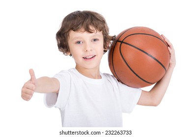 Portrait of a little boy with a basketball on a white background.