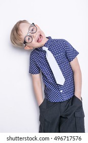 Portrait of a little boy in a funny glasses and tie. School. Preschool. Fashion. Studio portrait isolated over white background