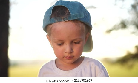 Portrait Of A Little Boy In The Park. Close-up Of A Boy In Nature. Happy Family Child Concept. Happy Boy Smiling. Cheerful Close-up Portrait Of A Little Boy. Child Outdoors In The Park Sunshine