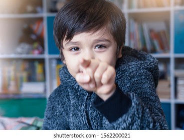 Portrait Of Little Boy Pointing Finger At Camera, Selective Focus Of Kid Primary School Boy Pointing At You With His Finger, Spoiled Children Concept