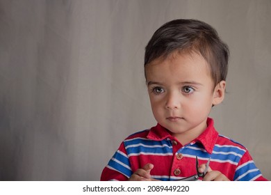 Portrait Of Little Boy Using Pliers