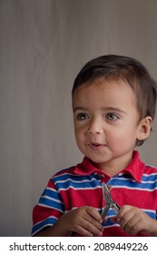 Portrait Of Little Boy Using Pliers