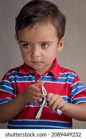 Portrait Of Little Boy Using Pliers