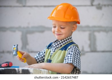 Portrait of little builder in hardhats with instruments for renovation on construction. Builder boy, carpenter kid with builder tools set. Repair home. - Powered by Shutterstock