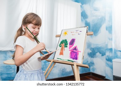 Portrait of little caucasian girl painting with copy space watercolor in her art kindergarten classroom. Young creative gifted artist home school education learning by doing back to school concept - Powered by Shutterstock