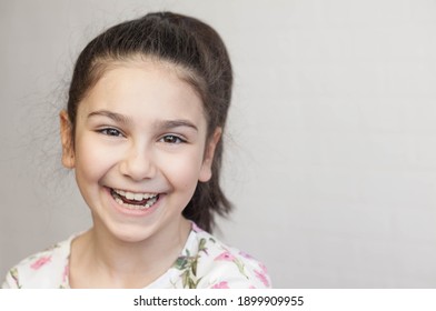 
Portrait of a little child girl laughing and looking at the camera. Positive emotions. - Powered by Shutterstock