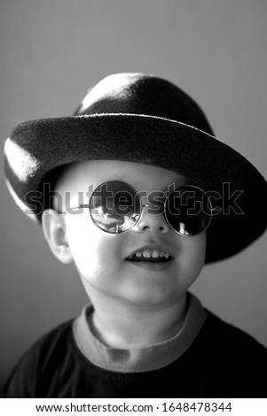 Similar – stylish little gentleman in hat looking up