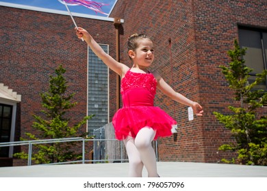 Portrait Of Little Cute Girl In Bright Pink Leotard Perform Making New Ballet Movement With Wang At Outdoor Stage In Downtown Vancouver WA USA At Hot Summer Day