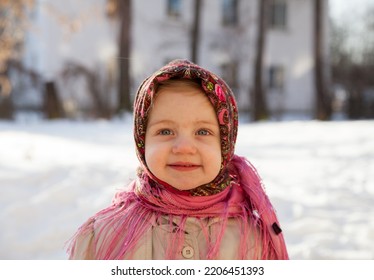 Portrait Of  Little Girl 3 Years Old In  Pink Russian Folk Scarf  In Winter