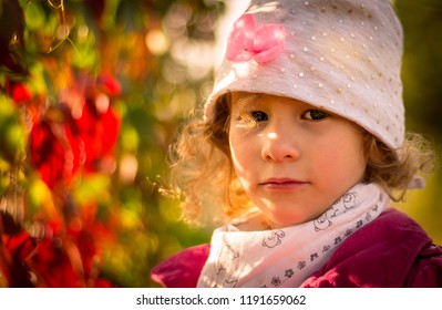 Portrait of little girl in an autumn colors.
