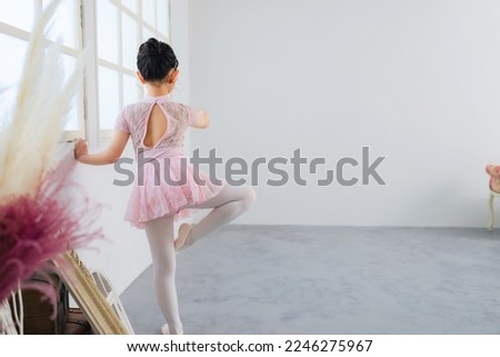 Portrait of little girl ballerina. dance lesson.