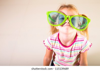 Portrait Of A Little Girl In Big Sunglasses