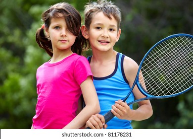 Portrait of a little girl and boy with badminton racket
