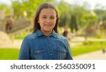 Portrait little girl child adopt kid innocence face adorable daughter smiling happy schoolgirl pupil school student in park city outdoors looking at camera health insurance pediatric custody childhood